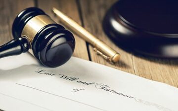A gavel resting on a document titled 'Last Will and Testament,' symbolizing legal proceedings related to testamentary law